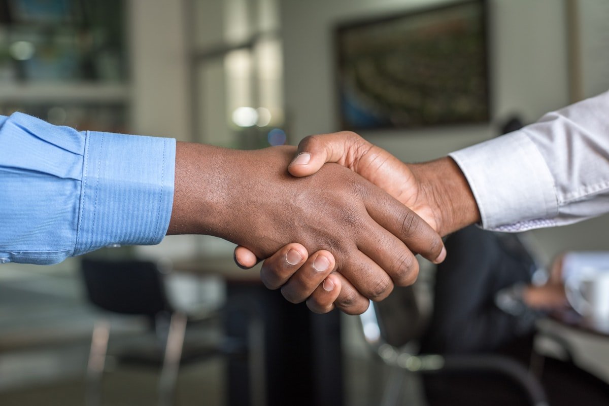 Professional bilingual business meeting — BizRevive connects San Antonio sellers with buyers from Mexico and Latin America